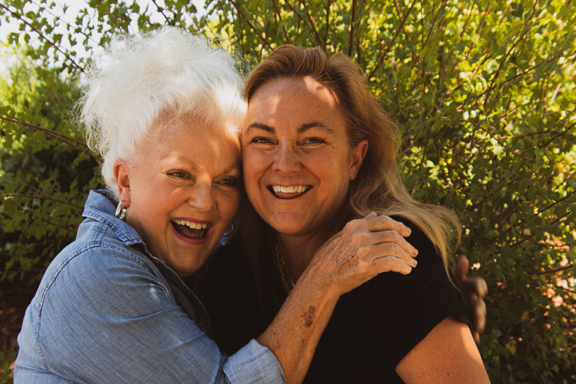Two women hugging and laughing