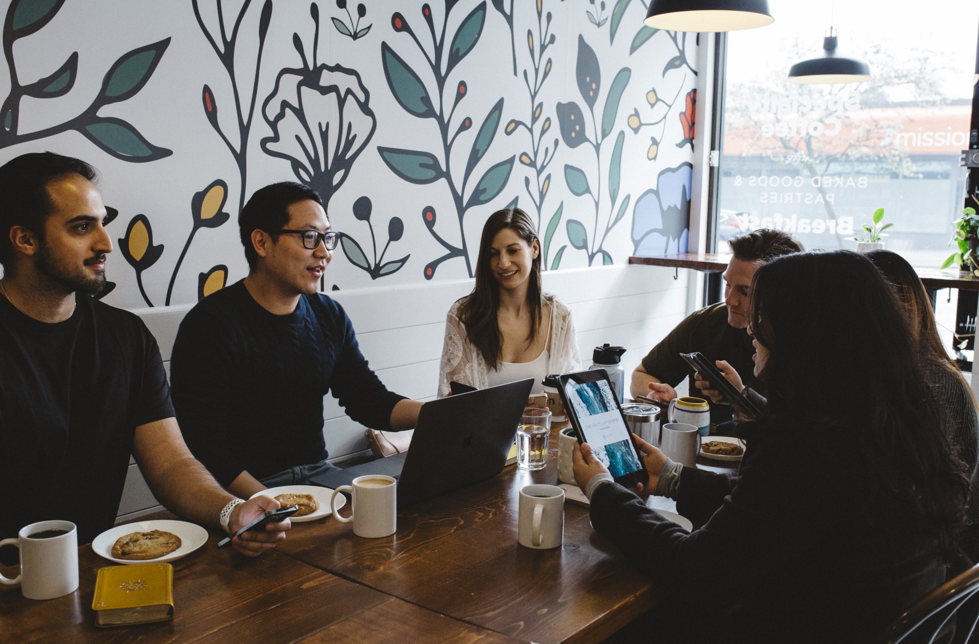 A group of people at a coffee shop view The Sanctuary Course
