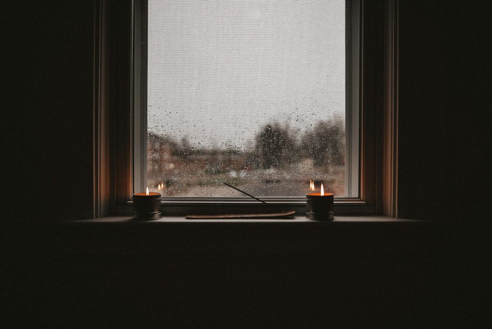 Header image for dismantling the silence of suicide. Depicts two candles sitting on a window ledge